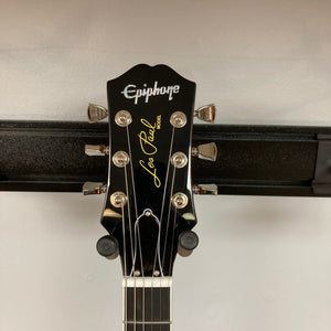 Epiphone Les Paul Modern Figured Mojave Burst guitar on a stand, featuring ProBucker pickups and Grover Locking Rotomatic tuners, comes with a gig bag.