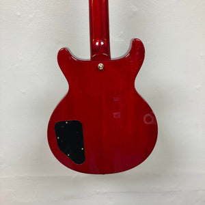 The back of the Epiphone Les Paul Special Double Cut Cherry Red w/Gigbag by Epiphone, showing its glossy finish, black cover plate, and neck joint detail, is pictured against a plain white wall.