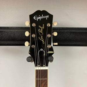 Close-up of the headstock on an Epiphone Les Paul Special Double Cut TV Yellow w/Gigbag, highlighting its tuning pegs and Epiphone logo against a plain background.