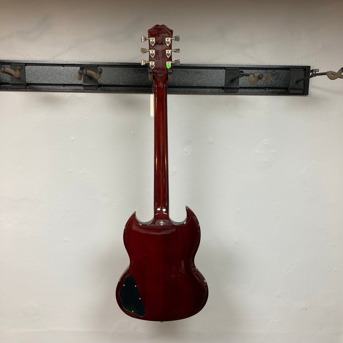Epiphone SG Modern Figured Mojave Burst guitar with ProBucker pickups, ebony fingerboard, and asymmetrical SlimTaper neck, displayed on a wall with included gig bag.