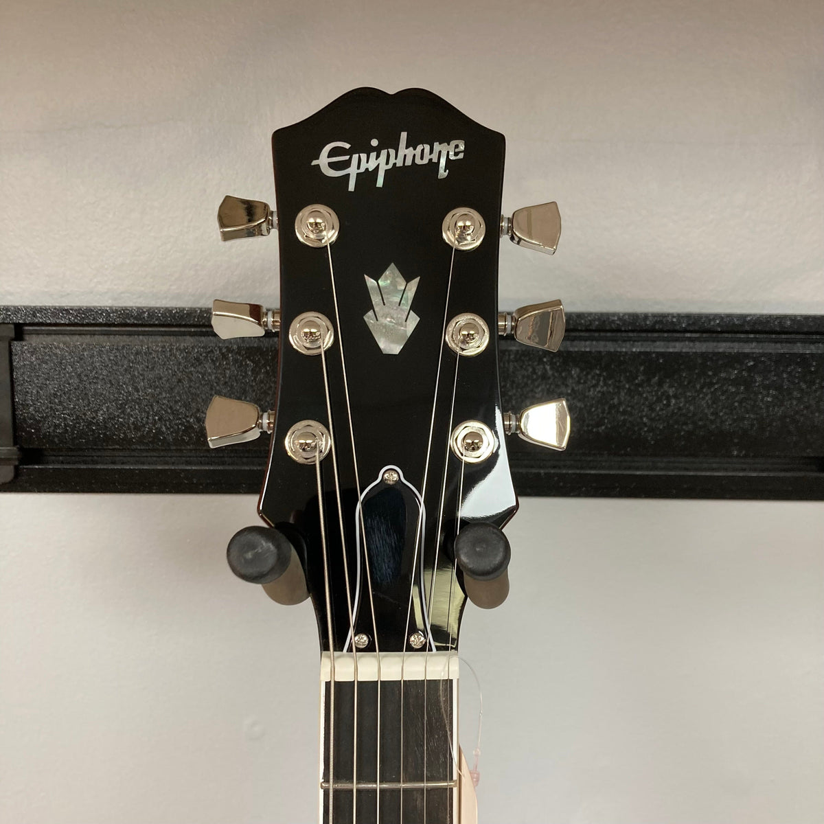 Epiphone SG Modern Figured Mojave Burst guitar on a stand, showcasing its mahogany body, maple cap, and ProBucker pickups. Includes a premium gig bag.