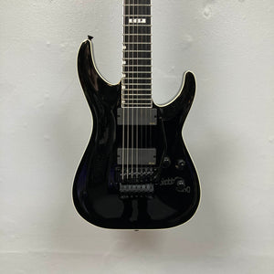 An ESP E-II Horizon FR-7 Black 7-string electric guitar by ESP with a glossy finish, Floyd Rose bridge, two pickups, white body binding, and whammy bar is pictured against a plain white background.