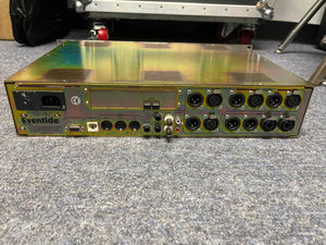 Rear view of a preowned Eventide H8000 Multi-Channel Effects System by Eventide, displaying XLR, MIDI, and power connectors on a carpeted floor.