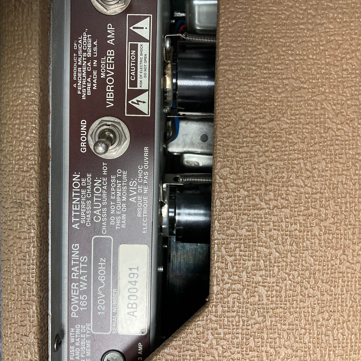 Close-up of the Fender '63 Vibroverb Reissue 40-Watt 2x10 Guitar Combo, highlighting the vintage-style brown control plate and detailed switches.