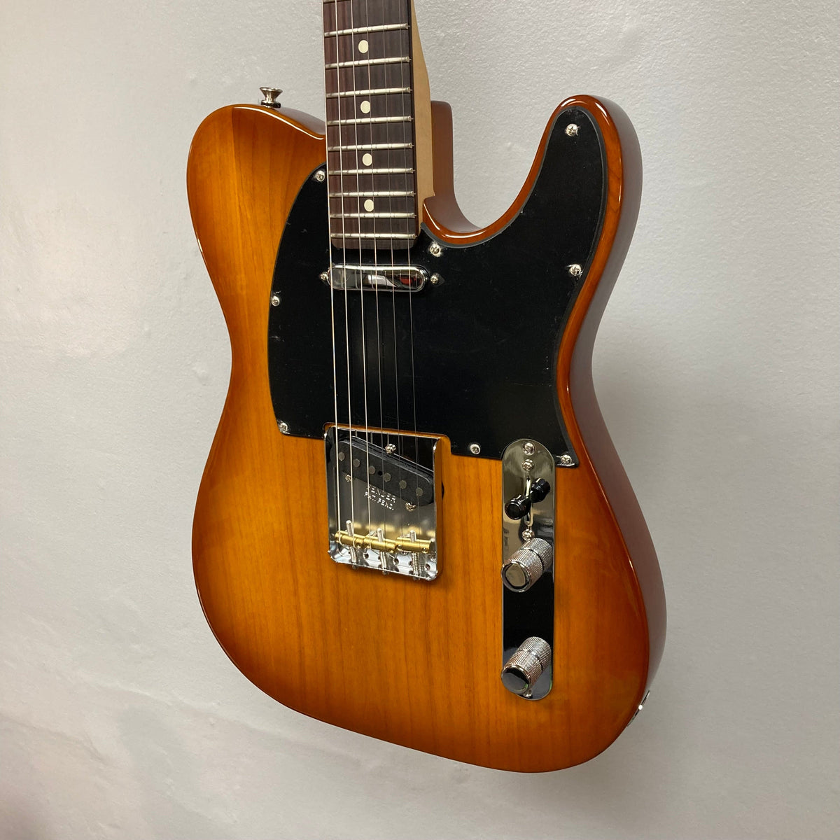 Fender American Performer Telecaster Honeyburst electric guitar on display, showcasing its maple neck and rosewood fingerboard, part of the refurbished collection at Guitars on Main.