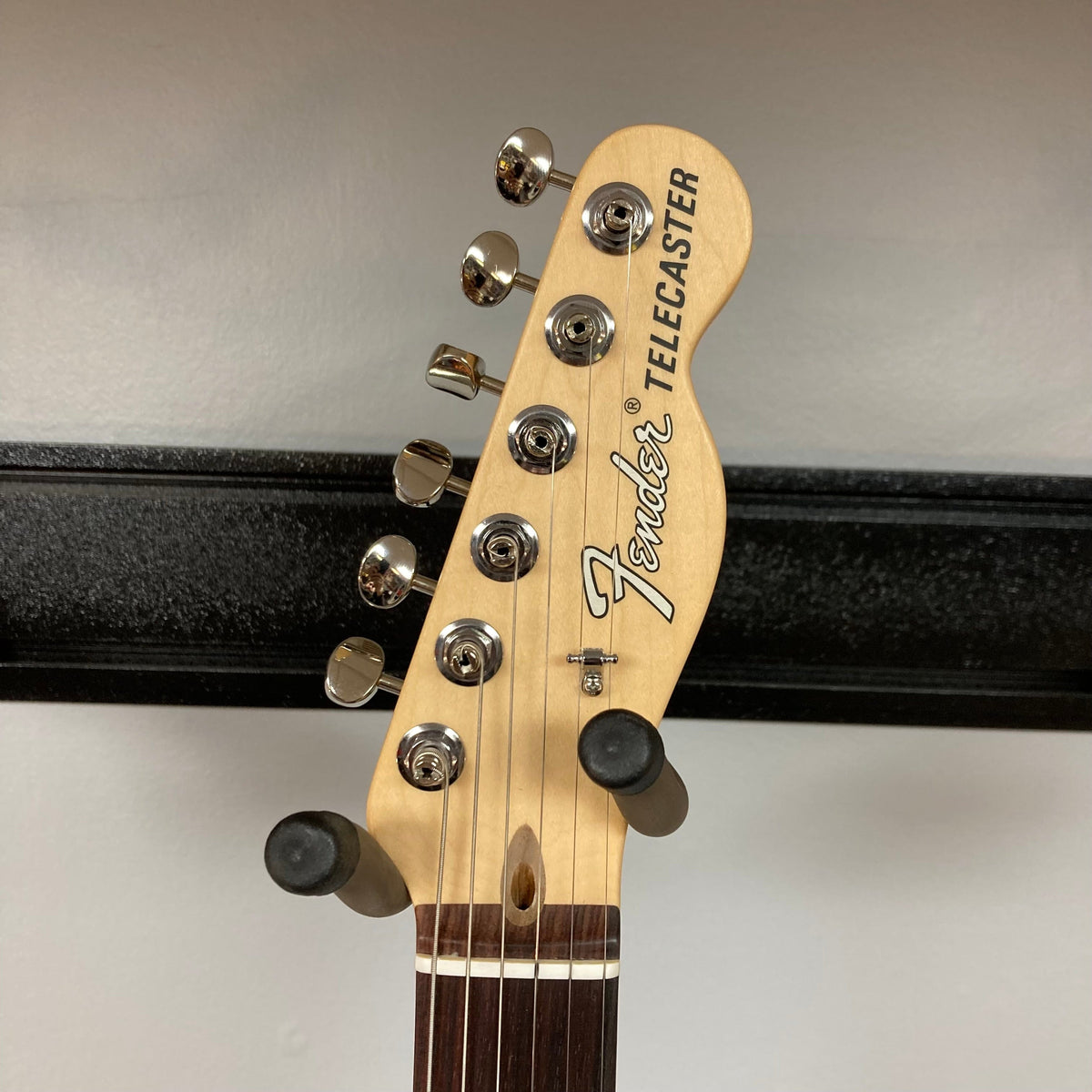 Fender American Performer Telecaster Honeyburst guitar head and neck close-up with tuning pegs and strings, highlighting craftsmanship and setup quality.
