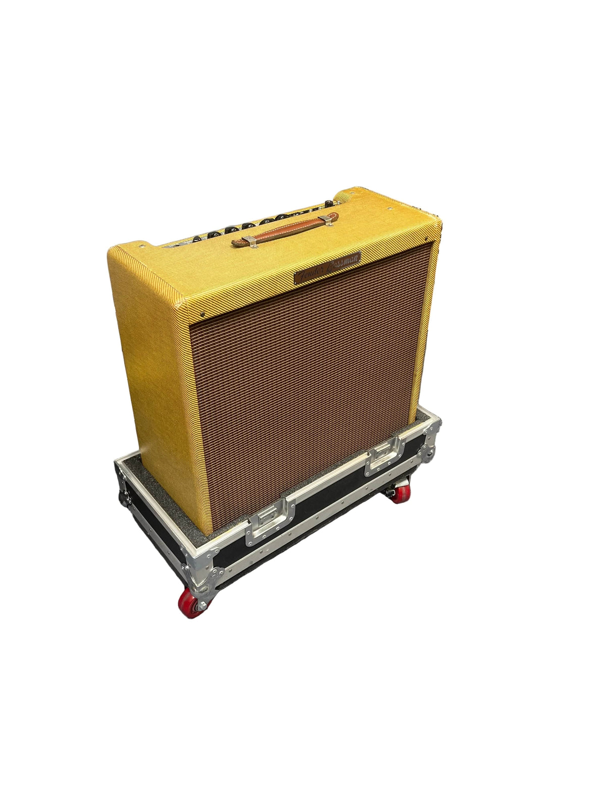 A 1957 Fender Bassman 5F6 Narrow Panel 40-Watt 4x10" Guitar Combo by Fender with a brown grill cloth rests on its flight case against a white background.