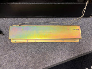 A metallic plate labeled "Accutronics" with wires, marked “9AB3C1B” and “Made in U.S.A.”, shown on gray carpet—a classic component found in the 1966 Fender Black Panel Twin Reverb 2x12" Combo Amp by Fender.