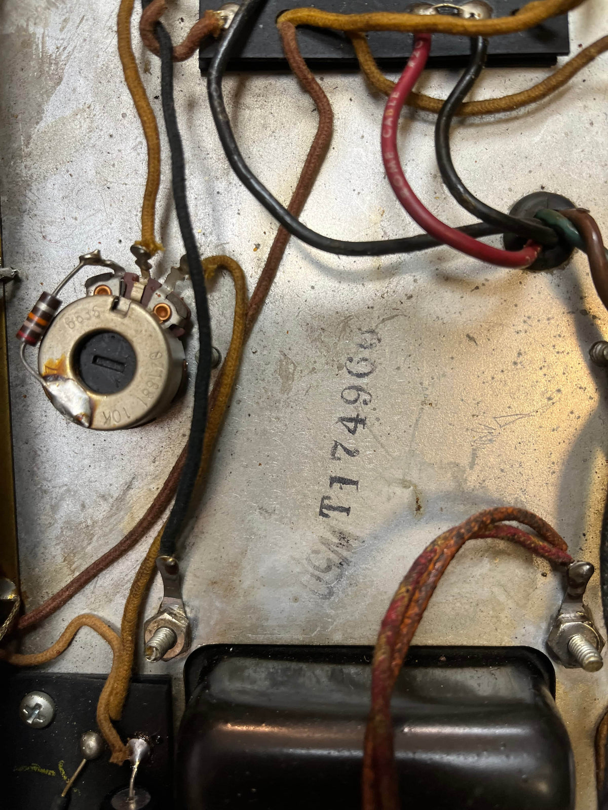 Close-up of electronic components, including a potentiometer, wires, and metal chassis marked "CM 174906," from a 1966 Fender Black Panel Twin Reverb 2-Channel 85-Watt 2x12" Guitar Combo Amp w/Case.