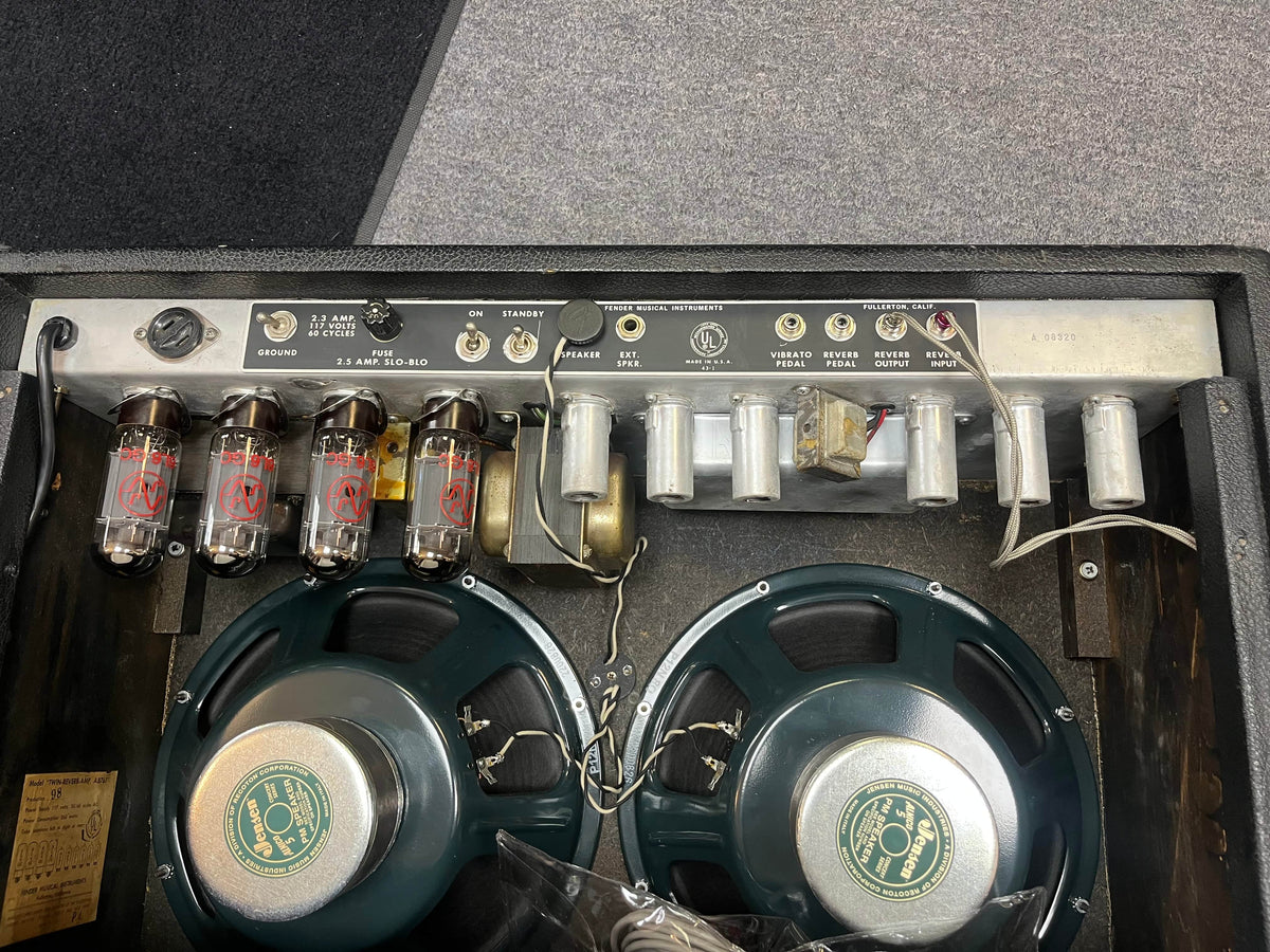 The image shows the interior of a 1966 Fender Black Panel Twin Reverb 2-Channel 85-Watt 2x12" Guitar Combo Amp w/Case, featuring vacuum tubes, electronic components, and two large green speakers.