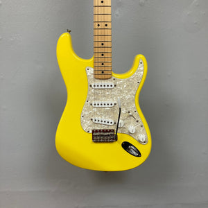 Fender Deluxe Powerhouse Stratocaster MIM Rare Graffitti Yellow w/Case, featuring high-output Noiseless pickups and advanced S-1 switching system, displayed on a wall.