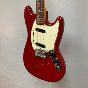 Fender Duo-Sonic II Dakota Red 1966 Vintage electric guitar with visible blemishes and heavy finish checking, displayed on a wall.