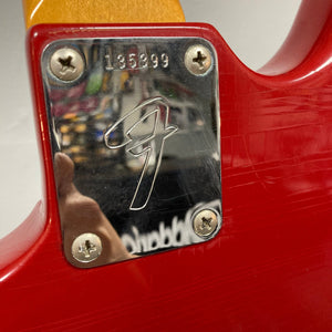 Close-up of a Fender Duo-Sonic II Dakota Red 1966 Vintage guitar, showing minor blemishes and heavy finish checking, with visible screws and metal components.