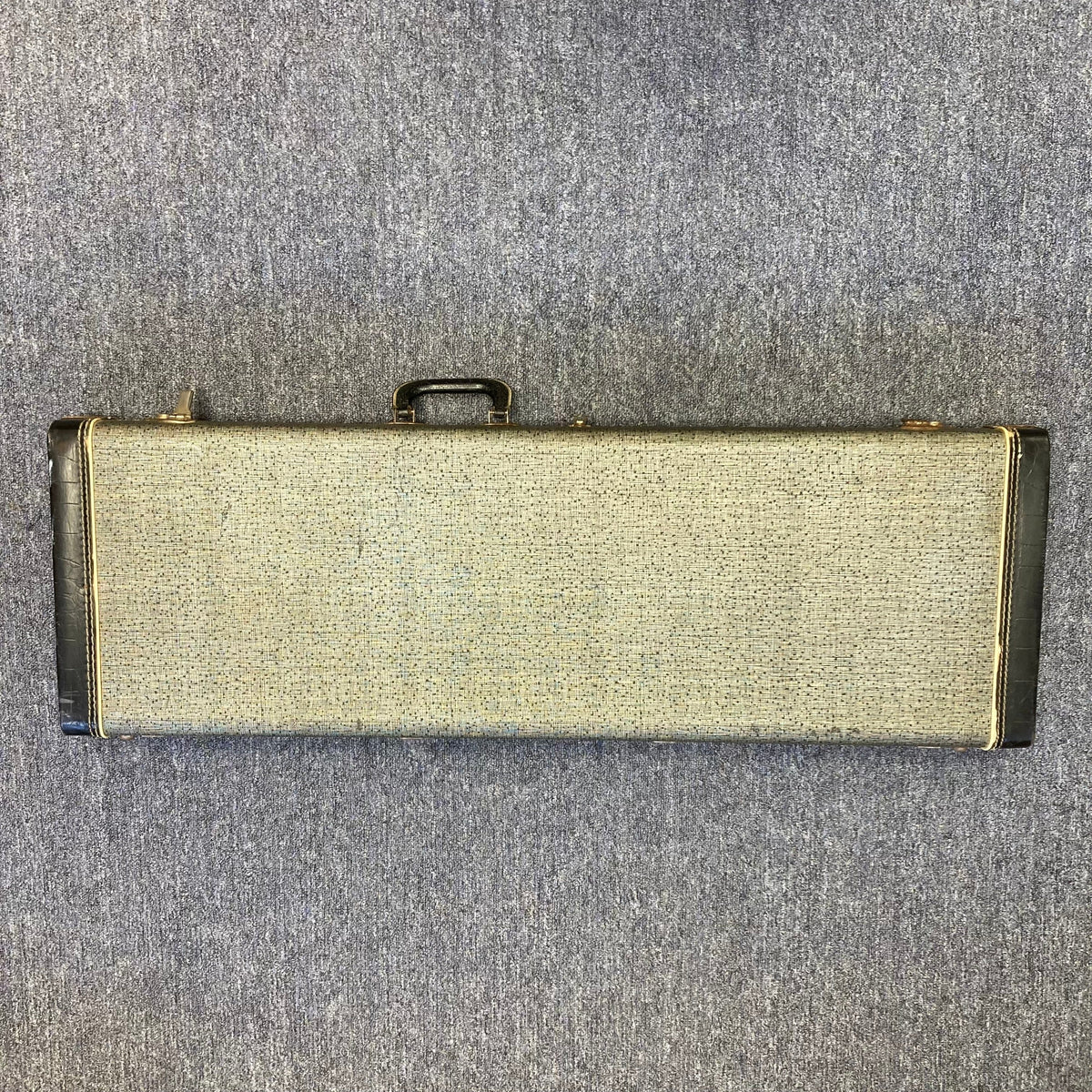 Fender Duo-Sonic II Dakota Red 1966 Vintage guitar with visible blemishes, resting in its case on concrete floor.