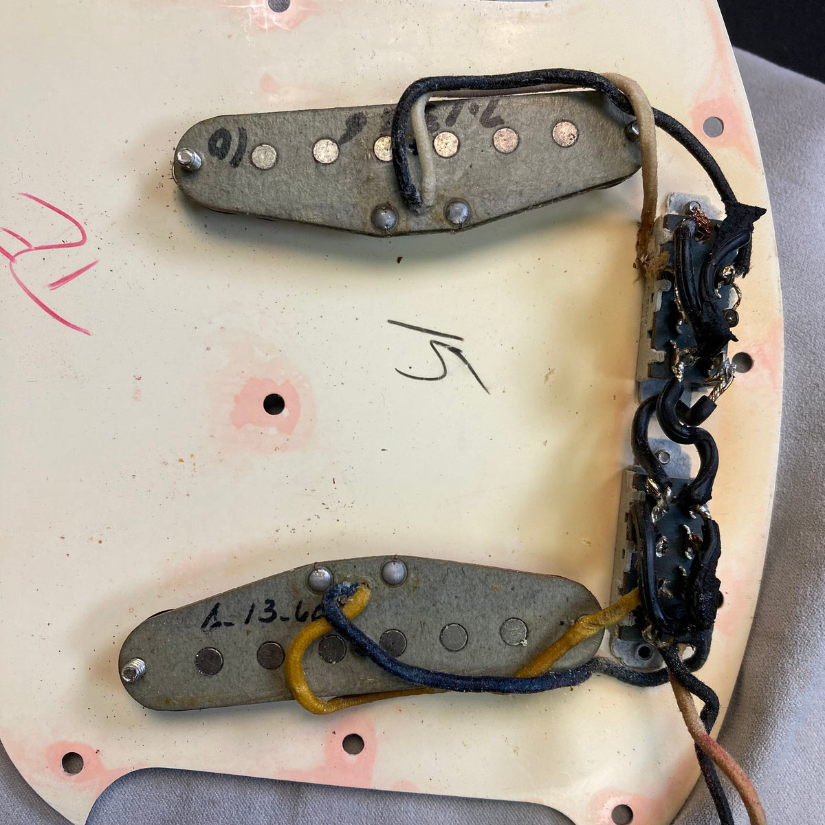 Close-up of a Fender Duo-Sonic II 1966 guitar showing minor blemishes and metal parts, highlighting its vintage condition and craftsmanship.