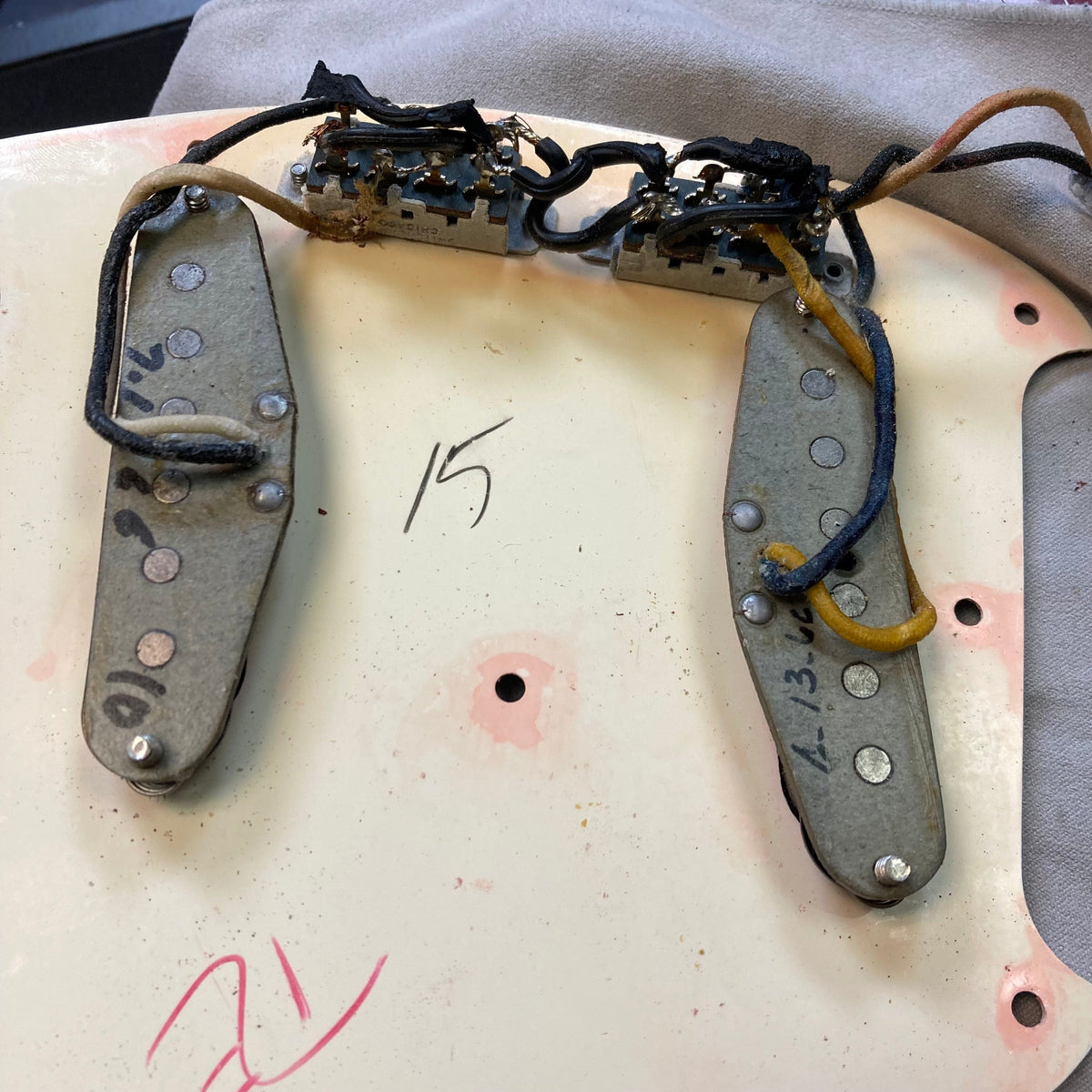 Close-up of a Fender Duo-Sonic II Dakota Red 1966 Vintage guitar showing the body, dual pickups, and minor blemishes.