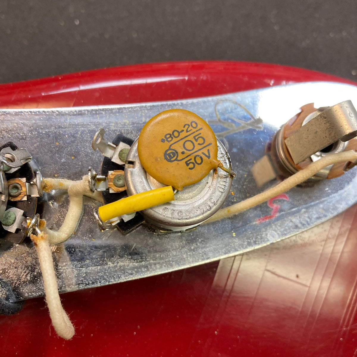 Close-up of a Fender Duo-Sonic II 1966 guitar with visible minor blemishes and heavy finish checking.