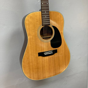 Fender F-35 1972-1981 Natural MIJ guitar, close-up of strings and body on display, showcasing its vintage craftsmanship and unique wood blend.