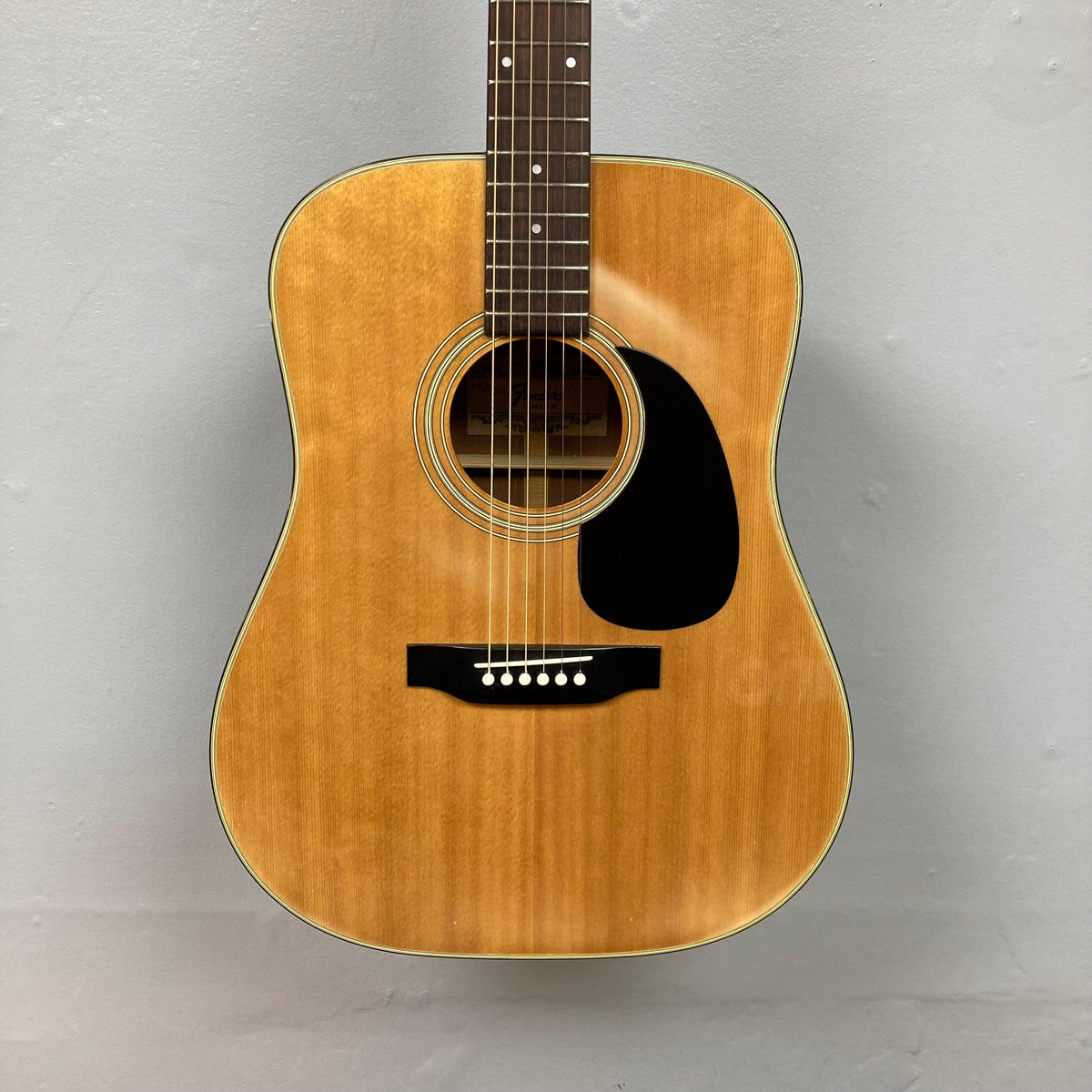 Fender F-35 1972 - 1981 Natural MIJ acoustic guitar on display, showcasing its elegant design and vintage craftsmanship.