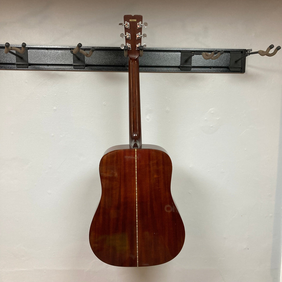 Fender F-35 1972-1981 - Natural MIJ guitar, showcasing a close-up view of its resonant Spruce top and rich Obankole sides, mounted on a wall.