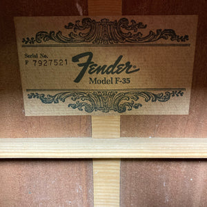 Fender F-35 1972 - 1981 - Natural MIJ label on a wood surface, highlighting its vintage craftsmanship and unique materials.