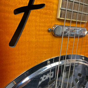 Close-up of the Fender FR-50CE Resonator showing guitar strings and intricate resonator details.