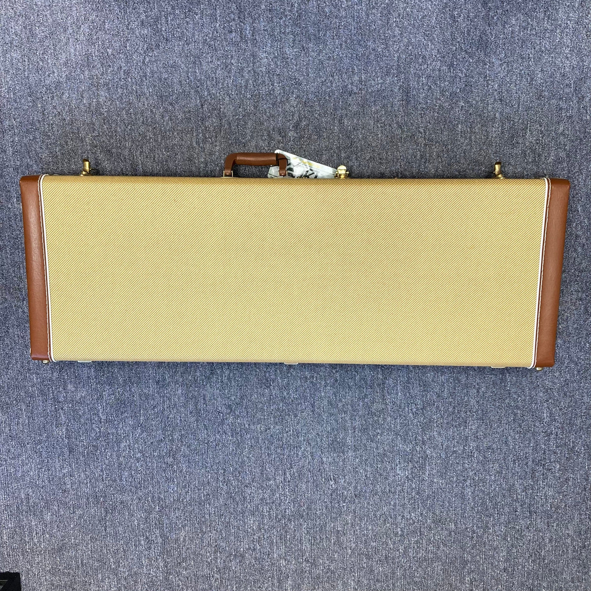 Fender Japan Stratocaster Candy Apple Red 2004 with original brown and tan case on carpet.