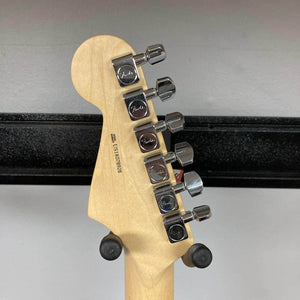 Close-up of the back of a Fender Limited Edition Ash American Professional Stratocaster in White Blonde, showing six chrome tuners and the channel-bound neck resting on a stand.