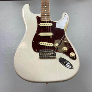 A Fender Limited Edition Ash American Professional Stratocaster in White Blonde with three single-coil pickups, knob controls, brown pickguard, and tremolo arm is shown against a gray background.