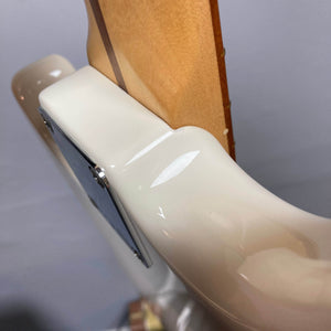 Close-up of the neck joint on a used Fender Mustang Player Bass PJ in white, highlighting the glossy cream body and natural neck wood. The image showcases the iconic short-scale design by Fender.