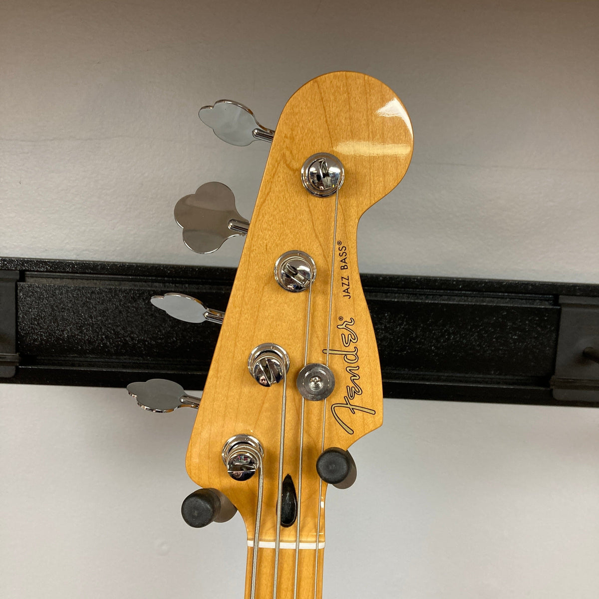 Fender Player II Jazz Bass Black Refurb close-up, highlighting its contoured body, modern neck profile, and single-coil pickups, showcasing classic Fender design and craftsmanship.