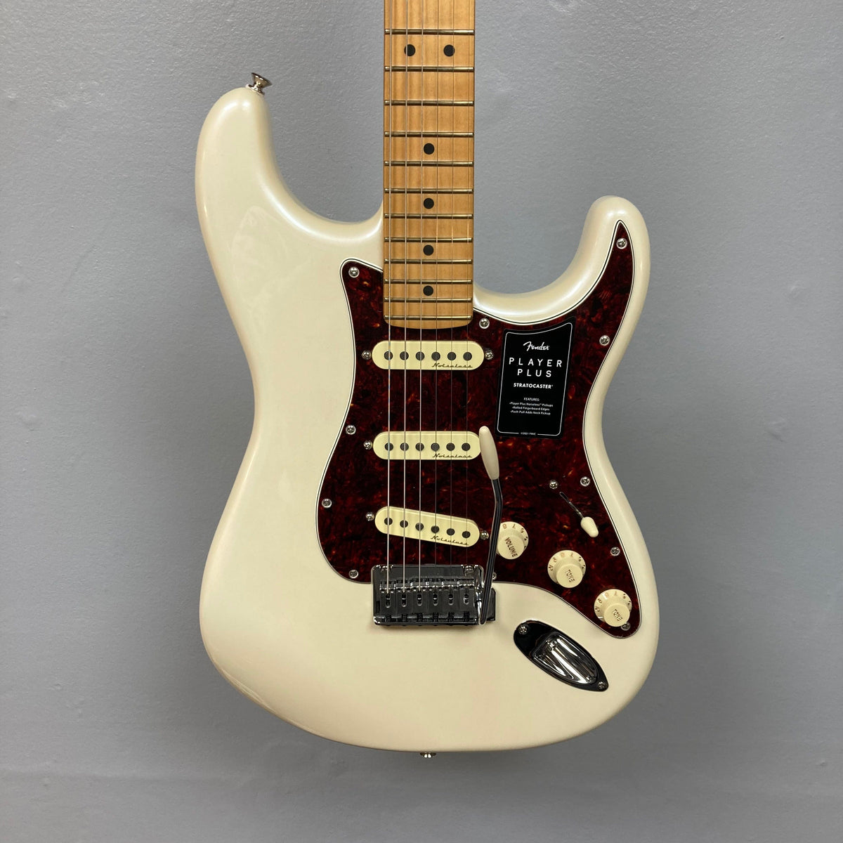 Fender Player Plus Stratocaster Olympic Pearl w/Gigbag Refurb: A white and red electric guitar with a sleek design and advanced features.
