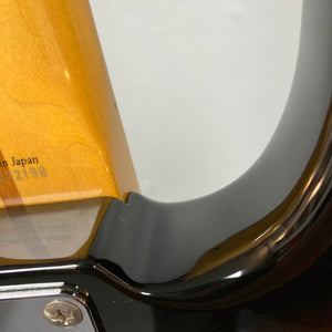 Close-up of a Fender Sting P Bass Sunburst neck joint by Fender, showcasing detailed wood grain, part of the serial number, and glossy finish—a great detail for fans of vintage-style electric bass guitars.