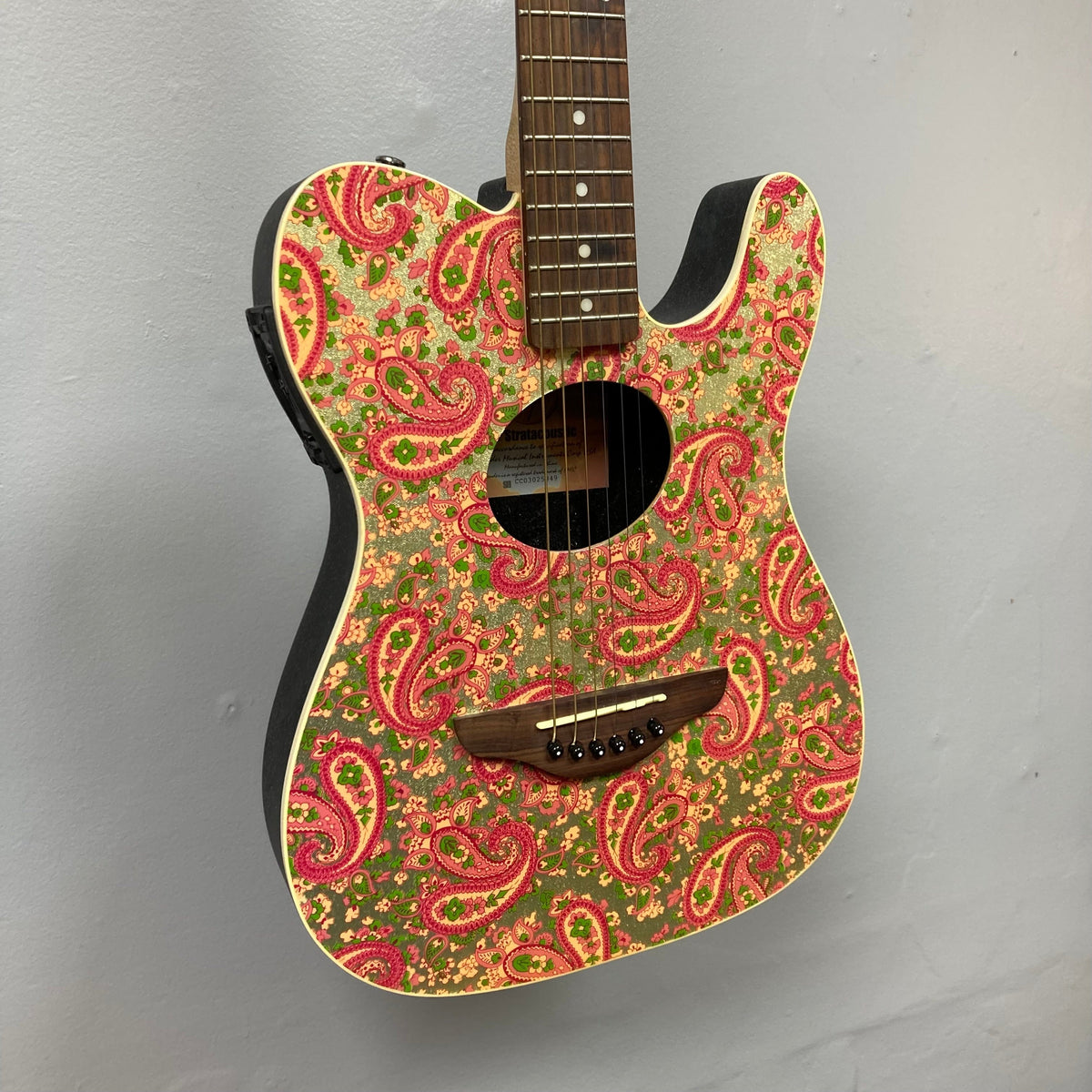 Fender Stratacoustic Pink Paisley guitar with intricate paisley design and built-in electronics, showcasing a blend of visual allure and exceptional sound quality.