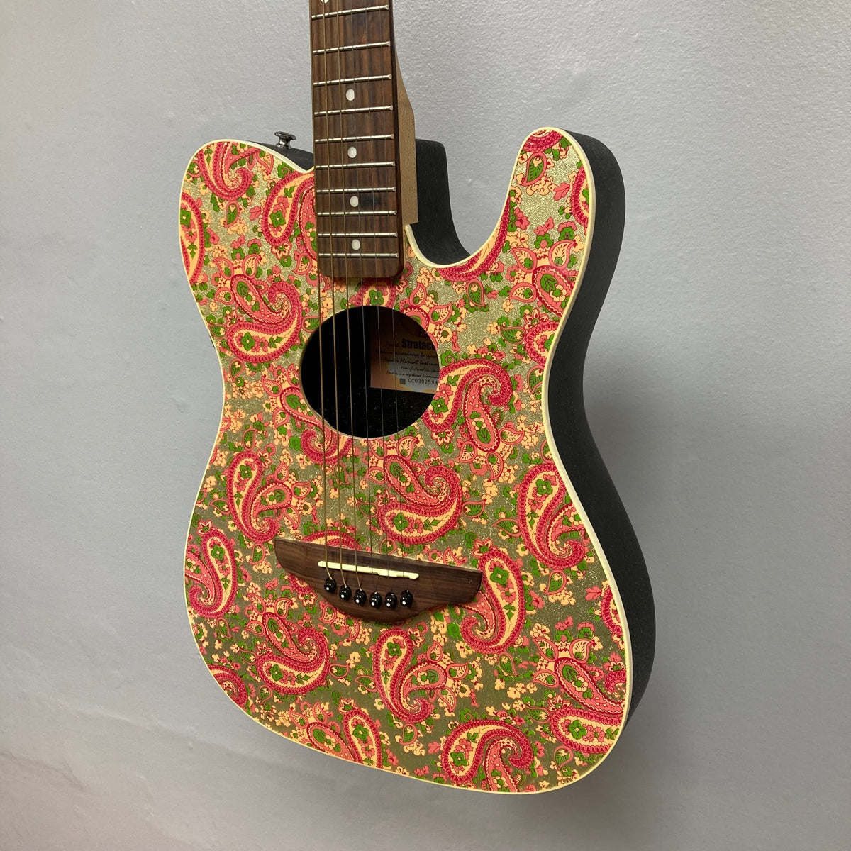 Fender Stratacoustic Pink Paisley guitar with intricate paisley design, slim body, and built-in electronics for versatile sound. Ideal for musicians.
