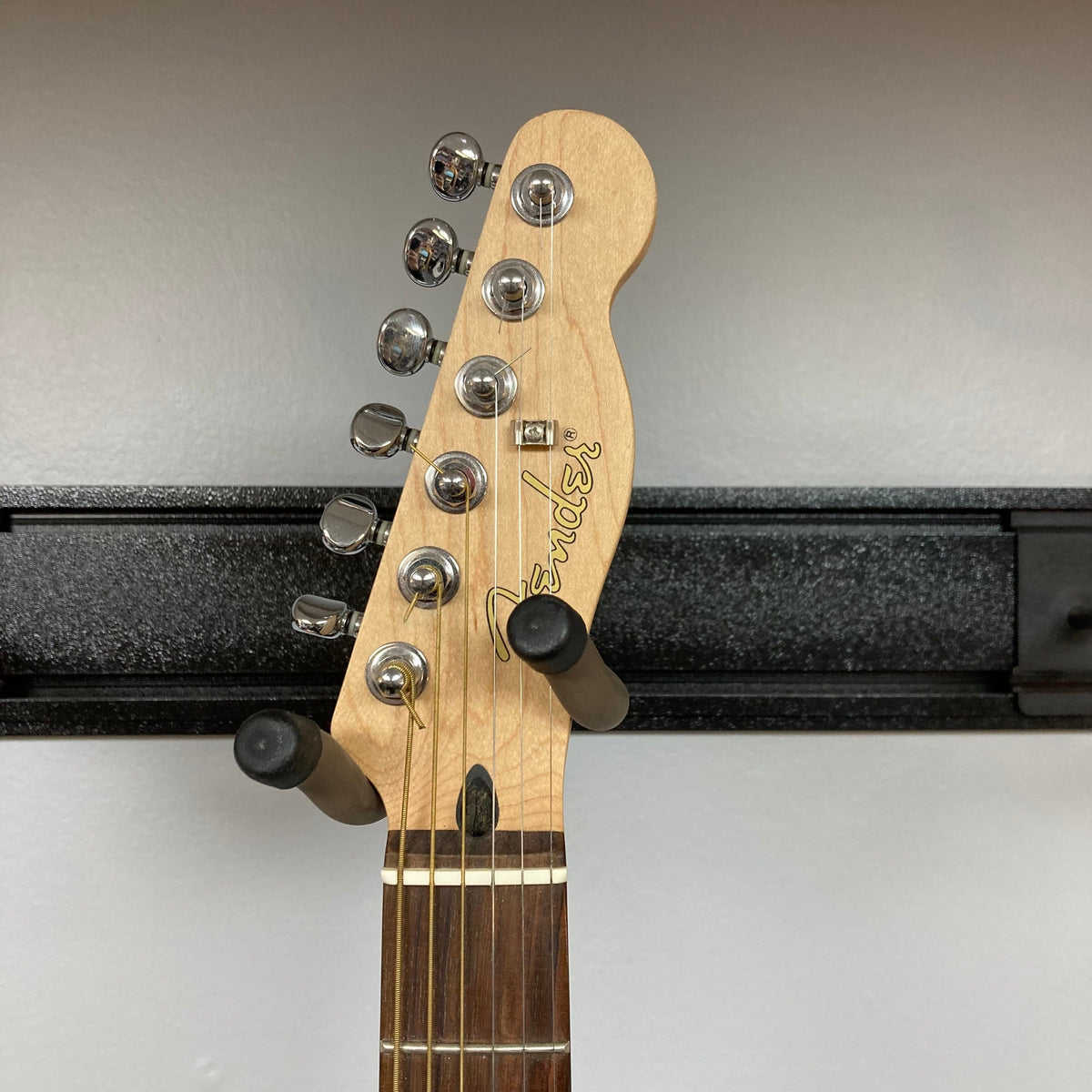 Fender Stratacoustic Pink Paisley guitar with pegs, showcasing a close-up of its elegant design and intricate detailing.