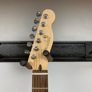 Fender Stratacoustic Pink Paisley guitar with pegs, showcasing a close-up of its elegant design and intricate detailing.