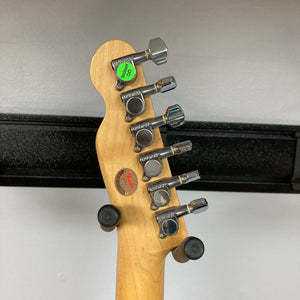 Close-up of a Fender Telecaster TLAC MIJ Acoustic/Electric Hybrid guitar, showcasing its detailed craftsmanship and vintage appeal.