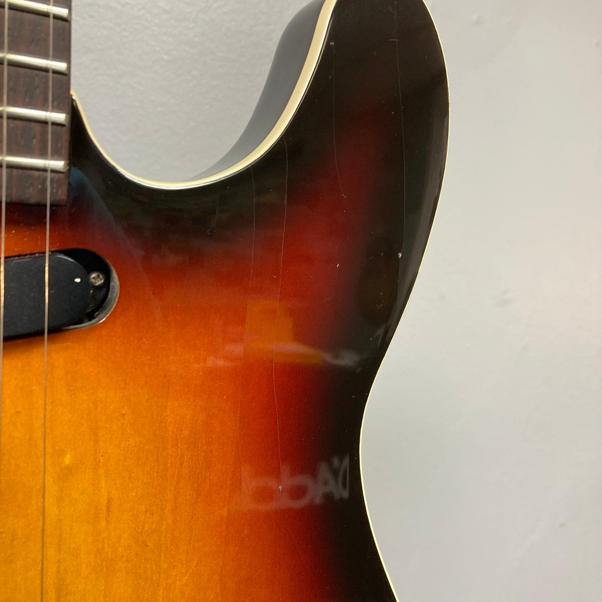 Close-up of the Fender Telecaster TLAC MIJ Acoustic/Electric Hybrid 1993-1997, showcasing its solid body and intricate string arrangement.