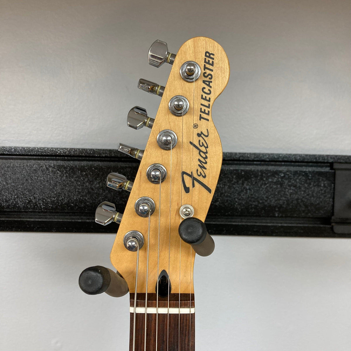 Fender Telecaster TLAC MIJ Acoustic/Electric Hybrid 1993-1997 on a stand, showcasing its sleek neck and hardware details.
