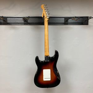 Fender Vintera '60s Stratocaster 3-Tone Sunburst Refurb w/Gigbag, featuring a classic-style tremolo bridge and Shaw-designed '60s pickups, mounted on a wall.