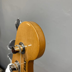 Fender Vintera '70s Jazz Bass close-up, showcasing vintage-style frets and single-coil pickups, highlighting its classic 1970s design.