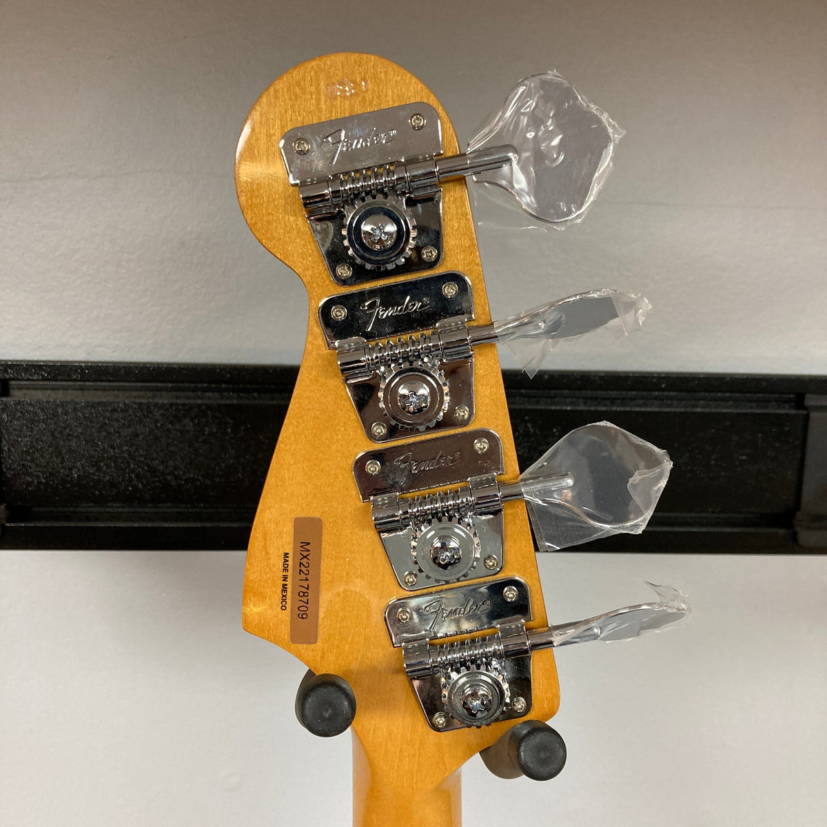 Fender Vintera '70s Jazz Bass close-up showcasing vintage-style tuning machines and '70s C-shaped neck, highlighting its classic design and craftsmanship.