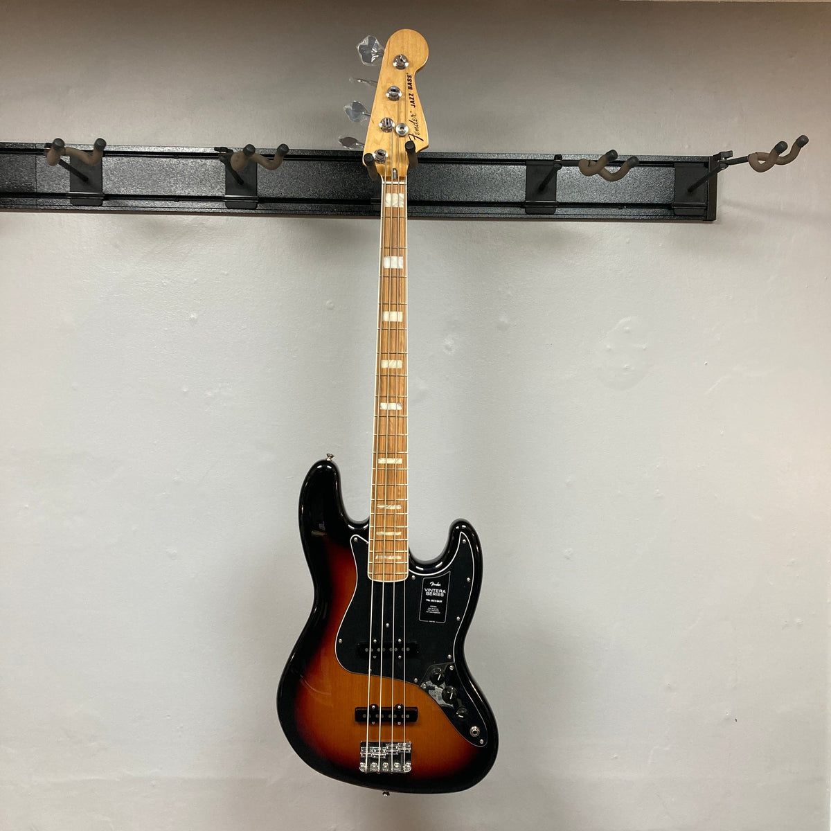 Fender Vintera '70s Jazz Bass on hook, showcasing its vintage-style neck and pickups for classic tone. Includes gig bag, set up for optimal playability.