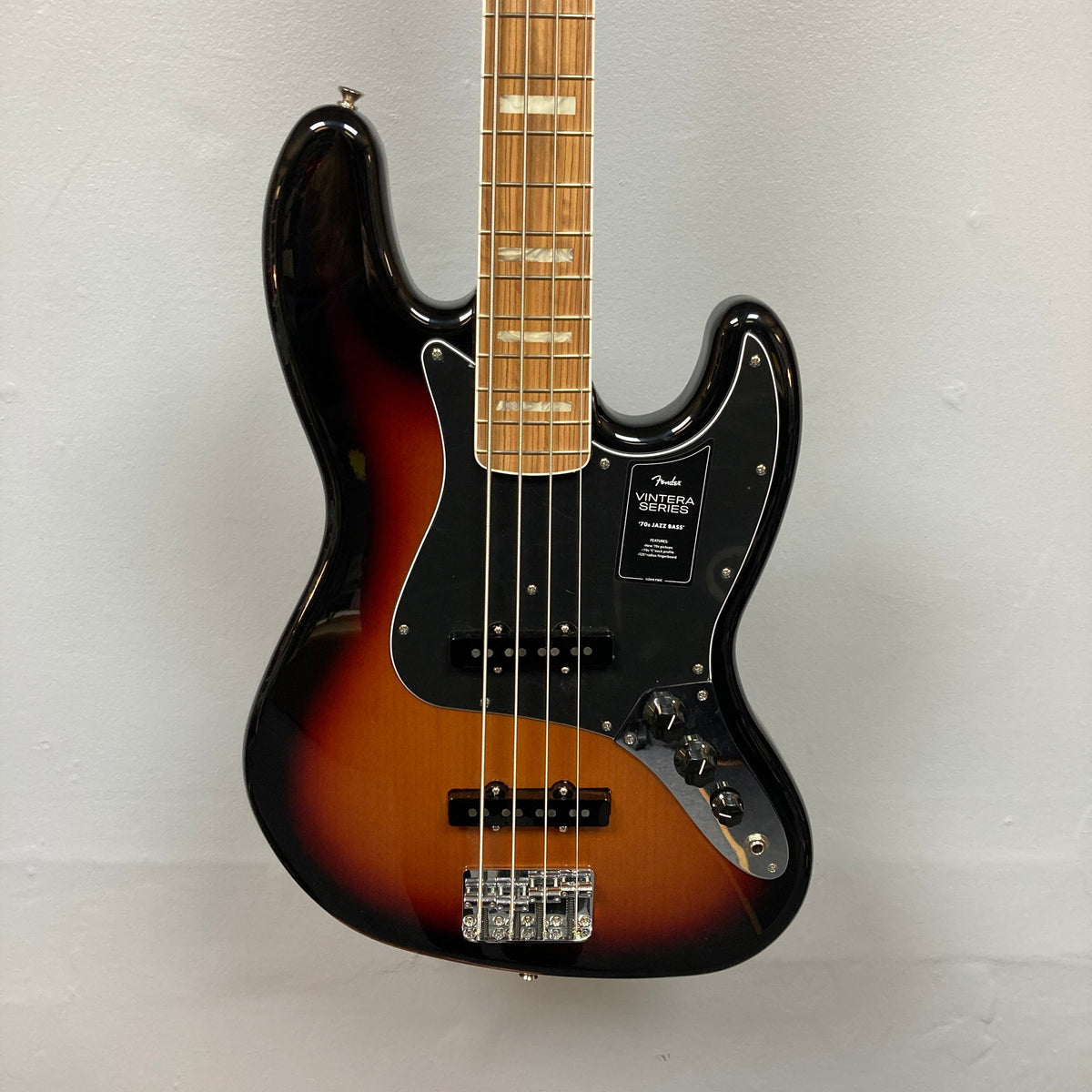 Fender Vintera '70s Jazz Bass close-up, highlighting strings and pickups; a vintage-style instrument ideal for classic tones and modern reliability. Includes gig bag.