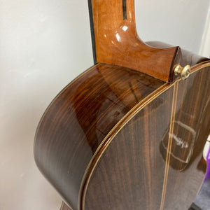 Giambattista G8 Natural Used guitar close-up, showcasing its detailed craftsmanship and high-gloss finish, highlighting features like the solid spruce top and precise binding.