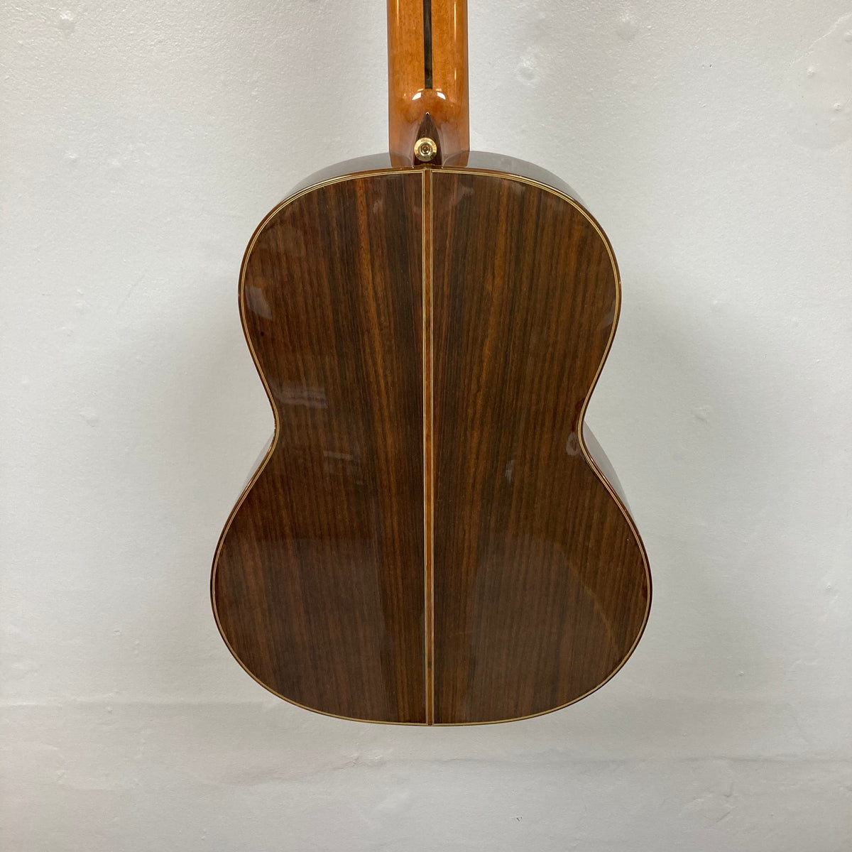 Close-up of a Giambattista G8 Natural Used classical guitar, highlighting its detailed craftsmanship and high-gloss finish, showcasing its quality construction.
