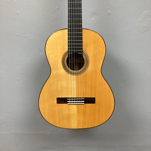 Giambattista G8 Classical Guitar on display, highlighting its detailed rosette and high-gloss finish, showcasing craftsmanship by Jean-Baptiste Castelluccia.