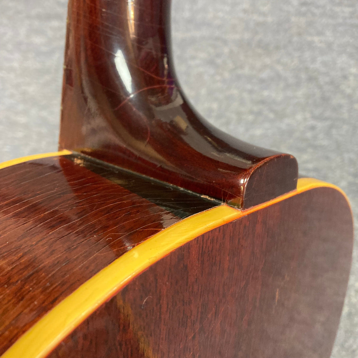 Close-up of a 1968 Gibson B-25 Acoustic Guitar showing detailed wood grain and string arrangement.