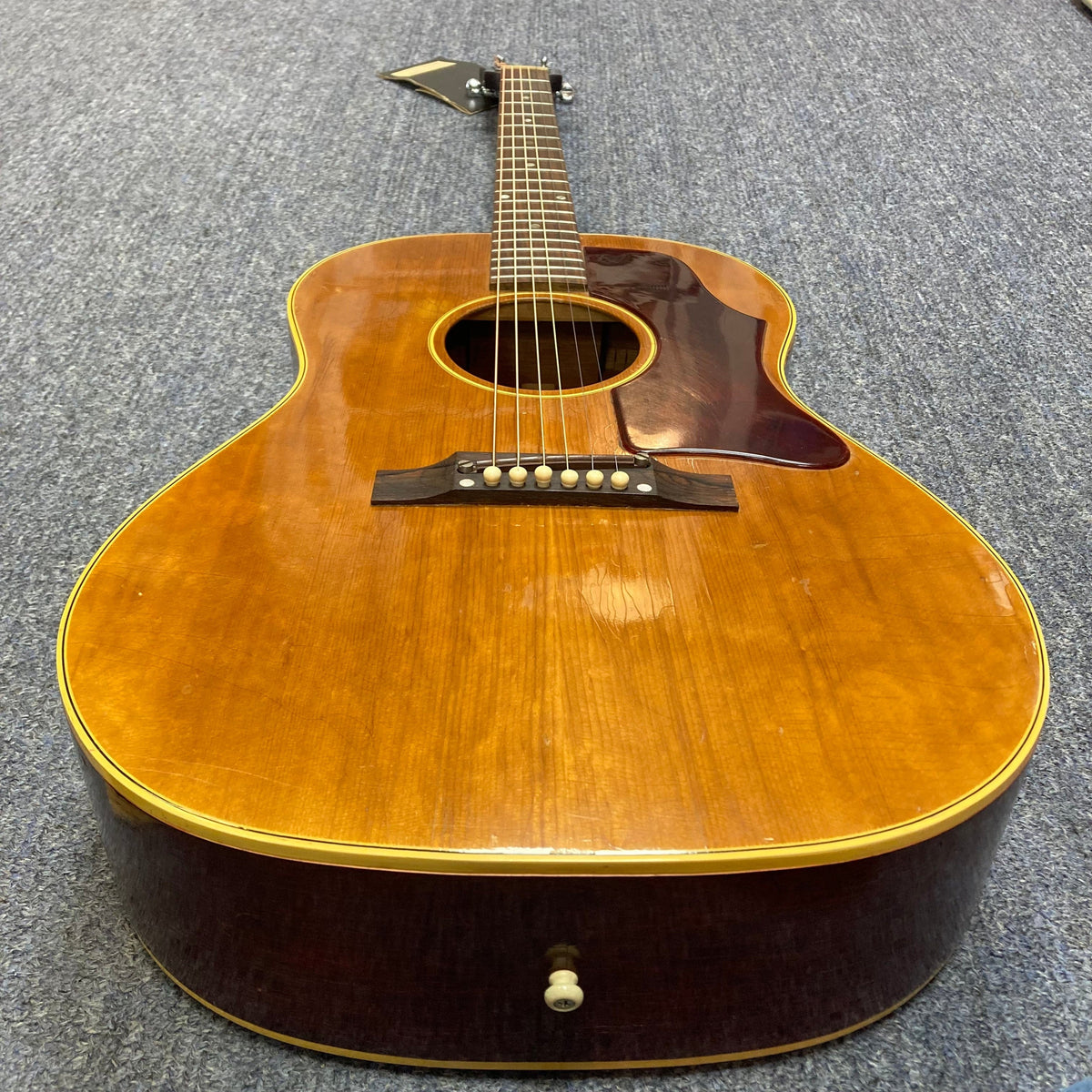 Gibson B-25 Acoustic Guitar Natural 1968 lying on the floor, showcasing checking on its body.
